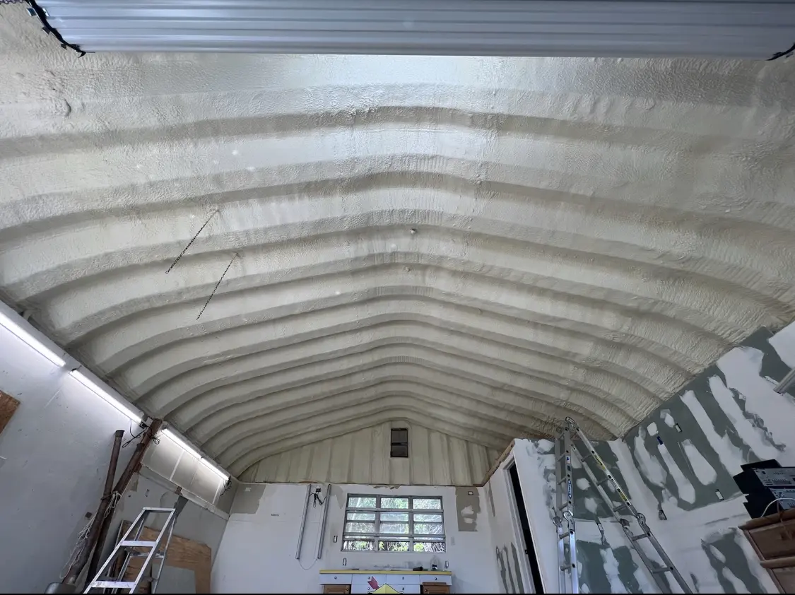 Spray polyurethane foam applied to the underside of a metal roof deck in Plains